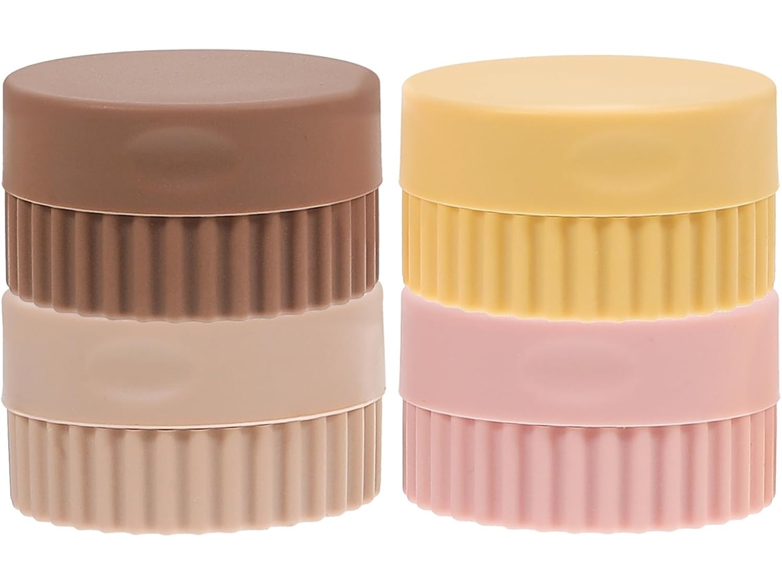Conjunto de 4 potes de silicone reutilizáveis para cosméticos, ideais para viagens.