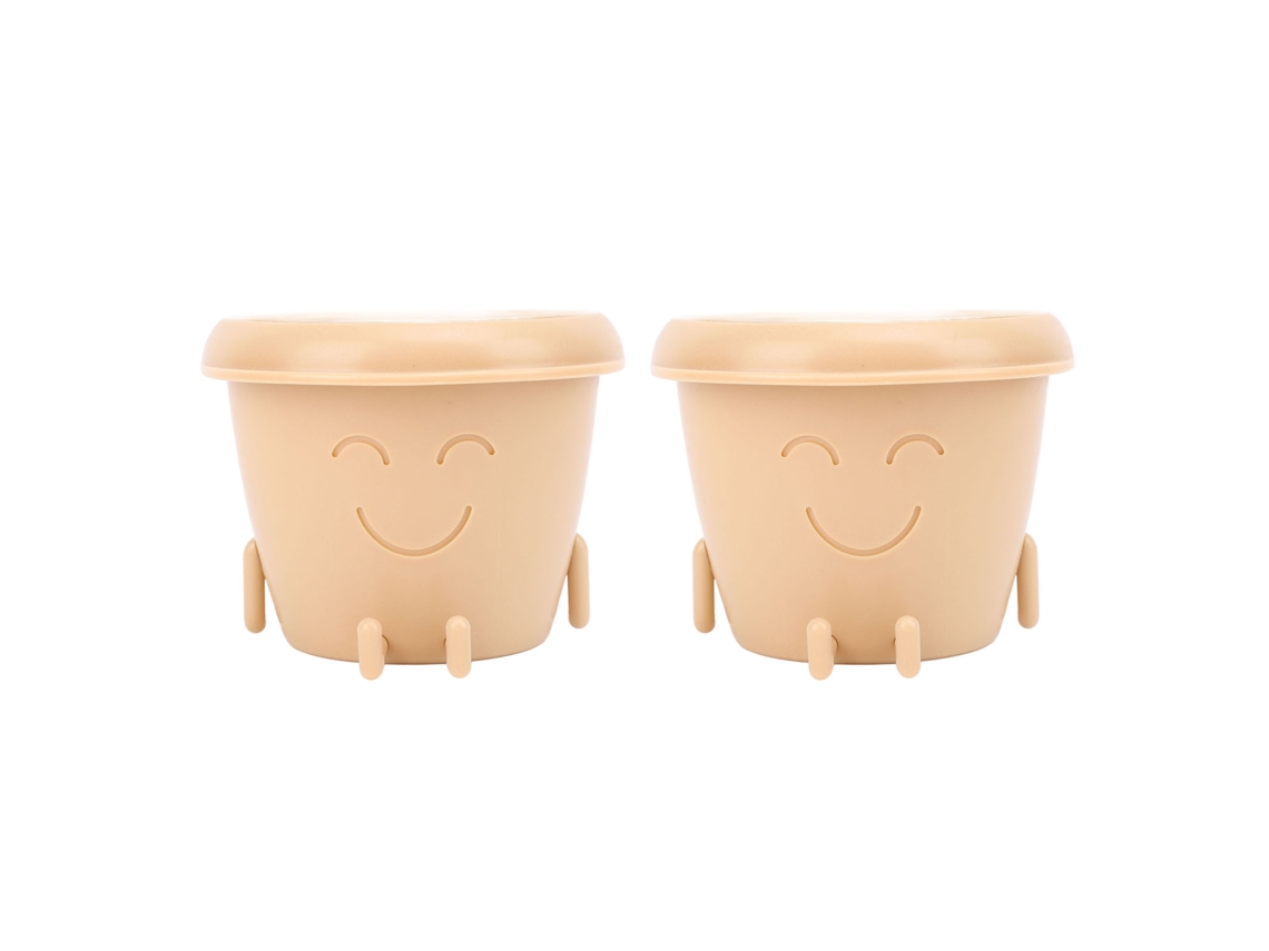 Primeiro vaso para suculentas com carinha sorridente, feito de plástico macio e pequeno, com pés de drenagem.