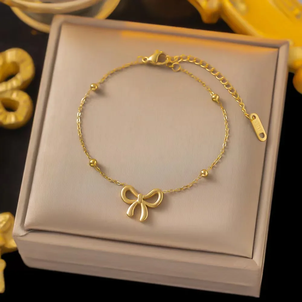 Conjunto De Colar E Pulseira Com Pingente De Laço Em Aço Inoxidável.
