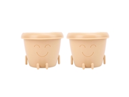 Primeiro vaso para suculentas com carinha sorridente, feito de plástico macio e pequeno, com pés de drenagem.